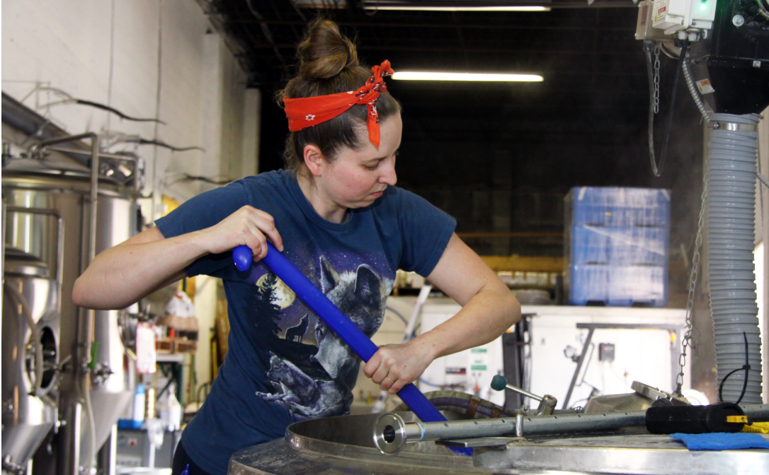A woman working in a beer brewery