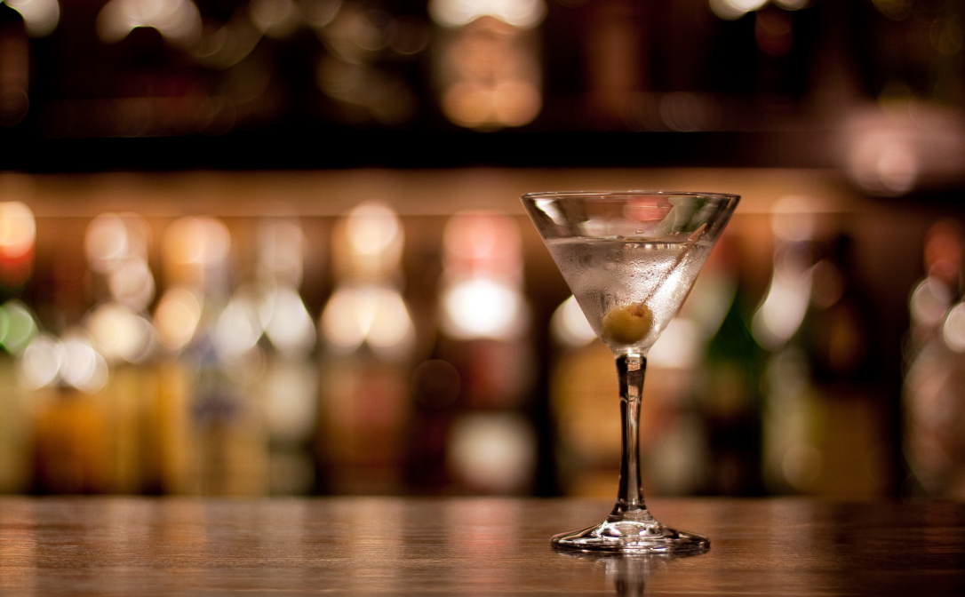 A martini cocktail, garnished with an olive