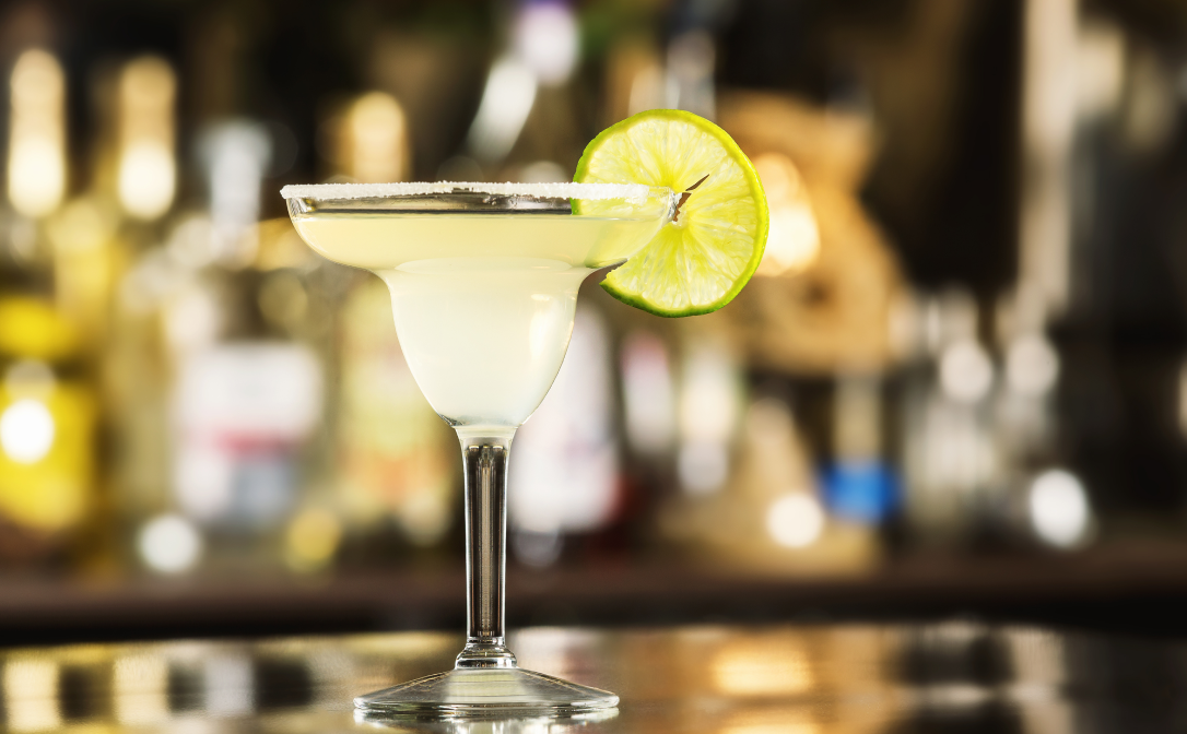 A Margarita cocktail, garnished with a bright green lime wheel