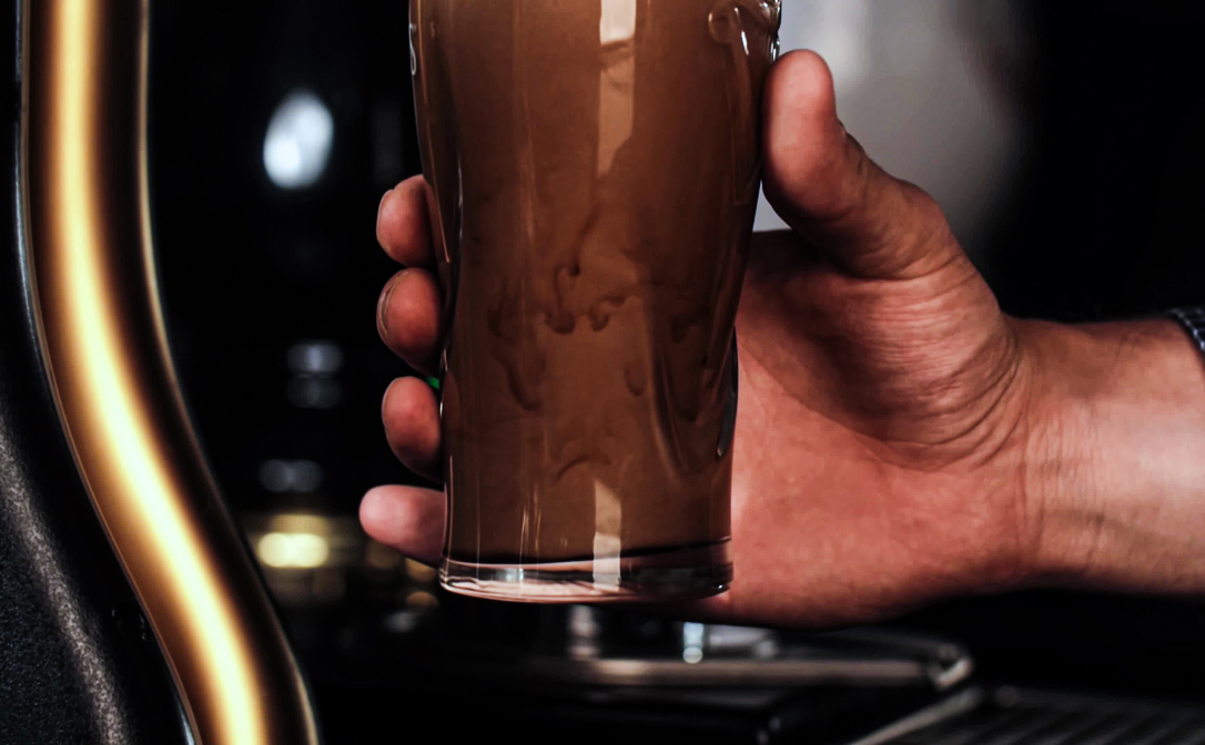 Stout being poured into a clear glass