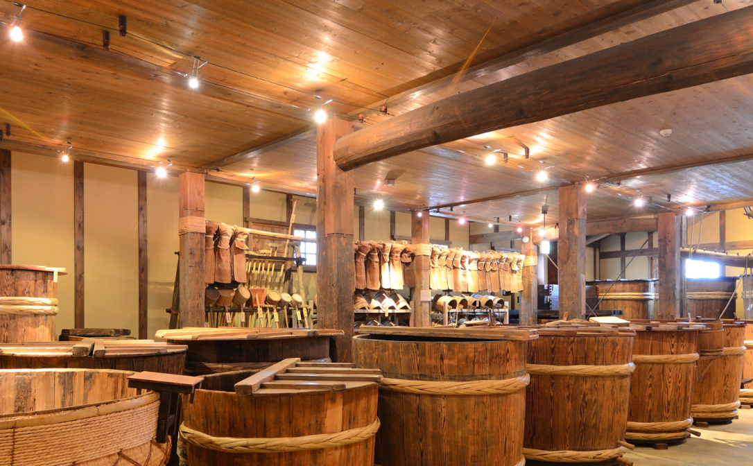 Wooden vats in a rustic building with wooden ceilings