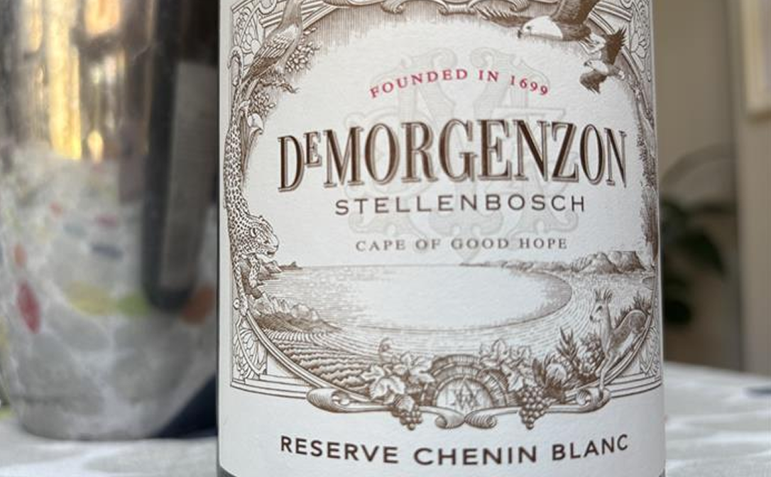 A pale coloured wine label with a light brown floral frame, bearing the words De Morgenzon Stellenbosch Reserve Chenin Blanc